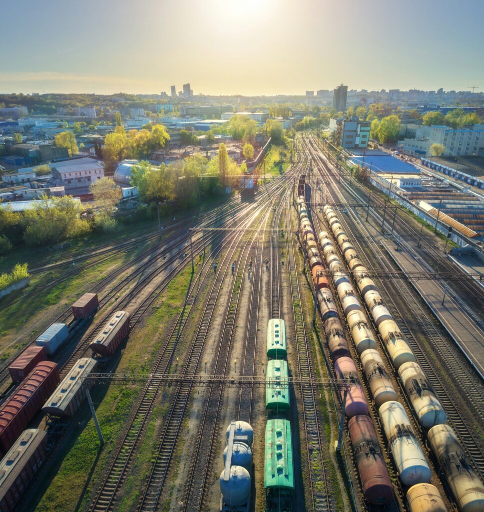 Aerial view of freight trains on railway station at sunset